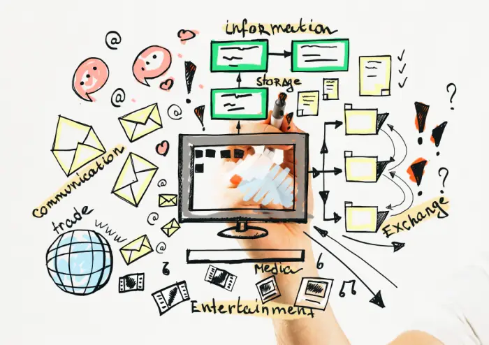 Small business owner creating content on a laptop at a desk with notes and a camera nearby