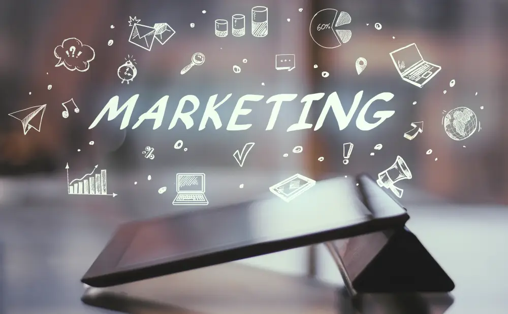 Small business team planning a digital marketing strategy around a laptop in an office